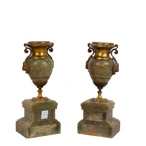 156 - Pair of Onyx and gilt ormolu decorated mantle urns, the gilded necks united to the body by two lion ... 