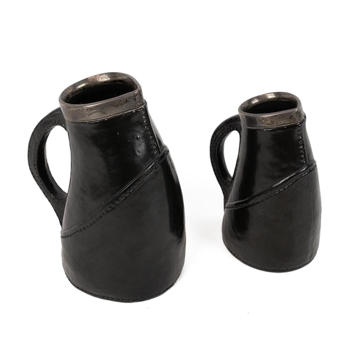 196 - Royal Doulton Lambeth 'Black Jack' jugs with silver collars hallmarked for London 1928 and 1929, mak... 