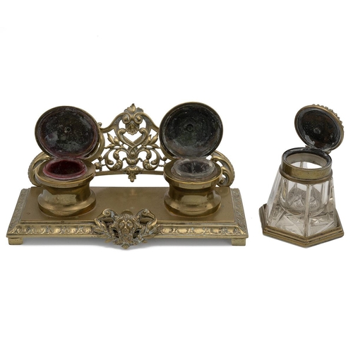 310 - A Rocco style twin brass desk inkwell with pierced gallery rail raised on a stepped base decorated w... 