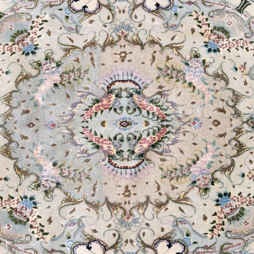 412 - 20th-century Iranian wool and silk Tabriz rug, decorated with a central medallion on a cream ground,... 