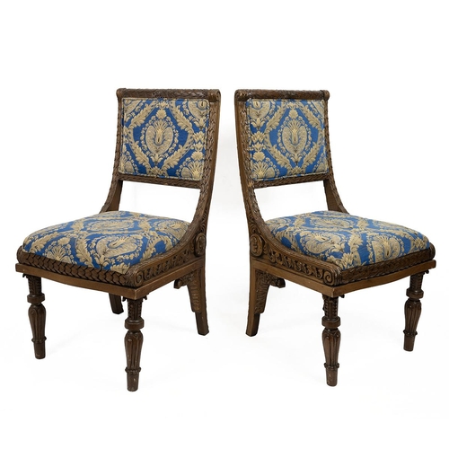 498 - East Asian heavily carved hall chairs with allover leaf and acanthus decoration, raised on turned le... 