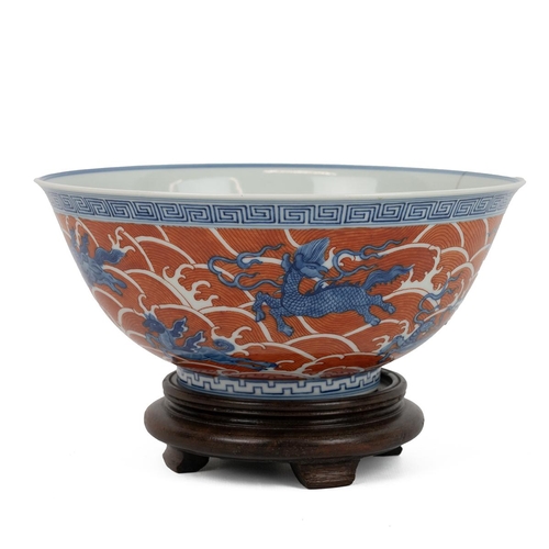 95 - A CHINESE FAMILLE ROSE BOWL ON WOODEN STAND, QINGRaised on short foot rim, decorated with dragons, s... 