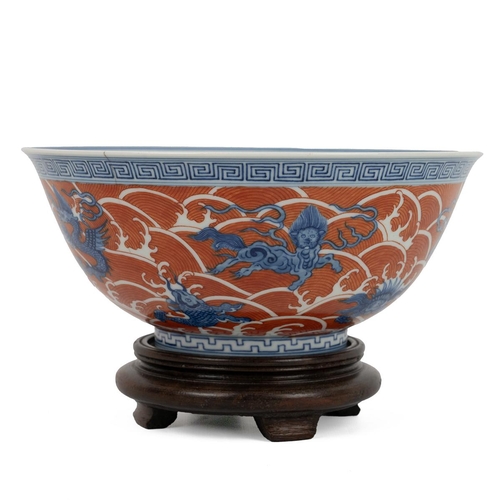 95 - A CHINESE FAMILLE ROSE BOWL ON WOODEN STAND, QINGRaised on short foot rim, decorated with dragons, s... 