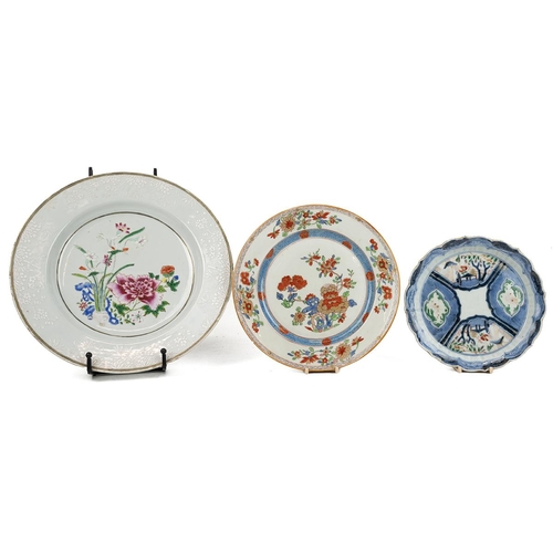 116 - THREE ORIENTAL PLATESThe Chinese famille rose plate, decorated with a flowering garden at the centre... 