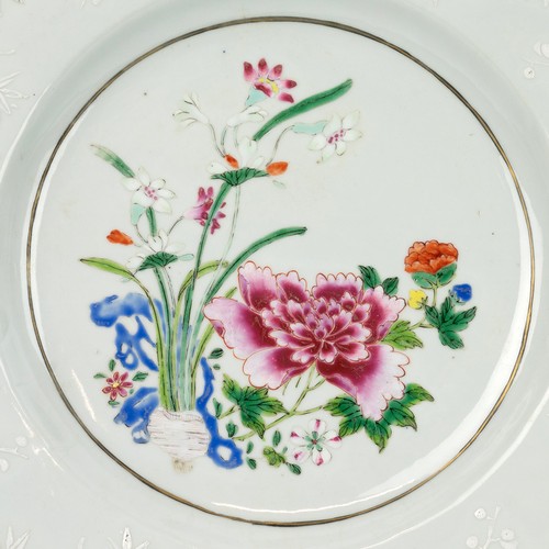 116 - THREE ORIENTAL PLATESThe Chinese famille rose plate, decorated with a flowering garden at the centre... 