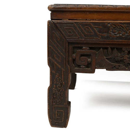 232 - A CHINESE HARDWOOD CARVED KANG TABLE, 19TH CENTURYOf rectangular form with carved floral motifs to t... 