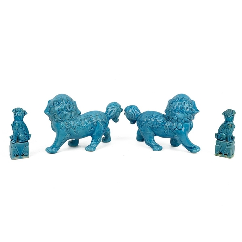 76 - TWO PAIRS OF CHINESE FOO DOGSTurqoise glaze. Larger pair each L 22cm, H 14cm; Smaller each H 11cm, W... 