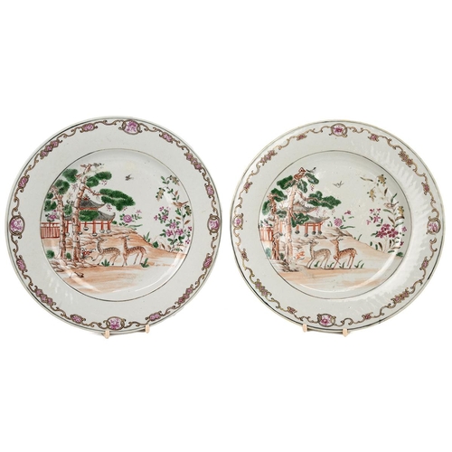 124 - A PAIR OF CHINESE FAMILLE ROSE PLATES, 18TH CENTURYDecorated with a gilt decorative border with pain... 