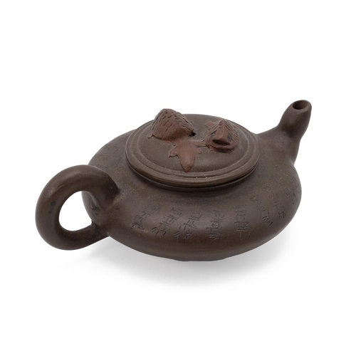 136 - A CHINESE YIXING ZISHA TEAPOT, 20TH CENTURYOf flattened circular shape, decorated with inscriptions ... 