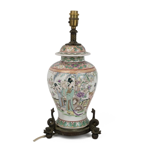 155 - AN ORIENTAL PORCELAIN VASE WITH COVER, 19/20TH CENTURYOf baluster form, on a brass base with three d... 