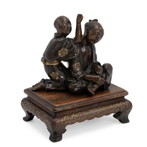 352 - A JAPANESE BRONZE FIGURAL GROUP DEPICTING A MASSEUR AND HIS CLIENT, MEIJI PERIOD Parcel gilt, depict... 