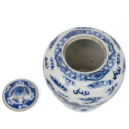 15 - A CHINESE BLUE AND WHITE JAR WITH COVER, 19TH CENTURYDecorated with dragons playing with a fireball ... 