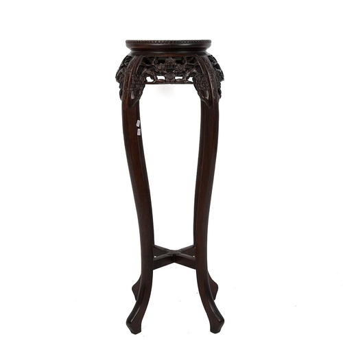 219 - A CHINESE HARD WOOD PLANT STAND.With pink marble inset to the top surrounded by a dragooned frieze a... 