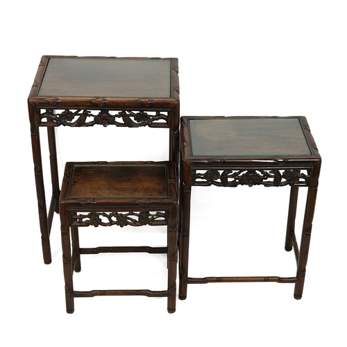 220 - A NEST OF THREE CHINESE ROSEWOOD SIDE TABLES, 19TH CENTURY.With glass inset to the top. Incorporatin... 