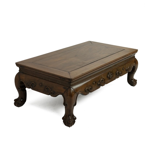 229 - A HUANGHUALI WOOD KANG TABLE, 19th CENTURY.Of rectangular form, the top above a shaped scrolled carv... 