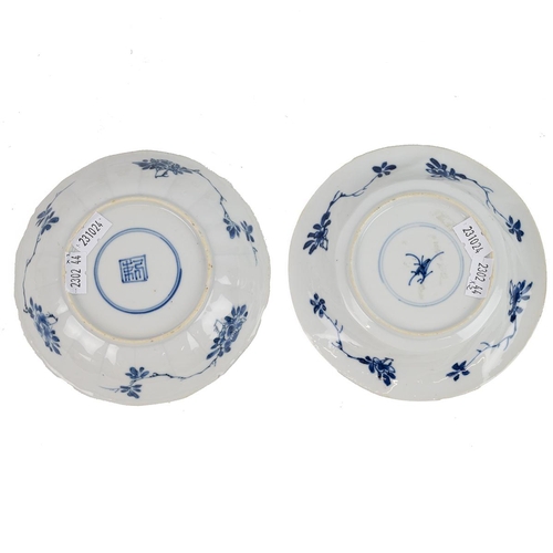 8 - TWO CHINESE BLUE AND WHITE SAUCERS, KANGXI PERIOD, QING DYNASTYBoth decorated with flowers and birds... 