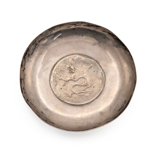 361 - VIETNAMESE SILVER DISH WITH A COIN TO THE WELL.The dish of circular form, the coin decorated with a ... 