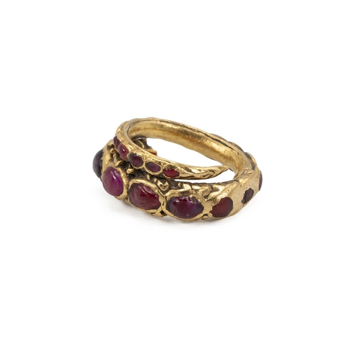 9 - Yellow metal and ruby Siam ring, early 20th Century. Set with various cabochon cut rubies, in the fo... 