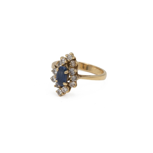 33 - Yellow metal and gem set cluster ring, set with an oval blue stone, surrounded by 12 brilliant cut w... 