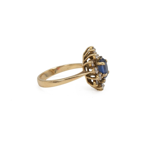 33 - Yellow metal and gem set cluster ring, set with an oval blue stone, surrounded by 12 brilliant cut w... 