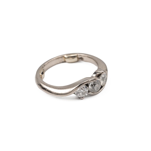 34 - White metal and three stone diamond ring, the twist stem with three brilliant cut diamonds, measurin... 