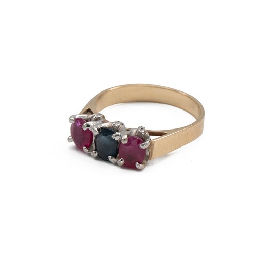 45 - Yellow metal, sapphire and ruby three stone ring in a claw setting with three mixed cut stones, fing... 