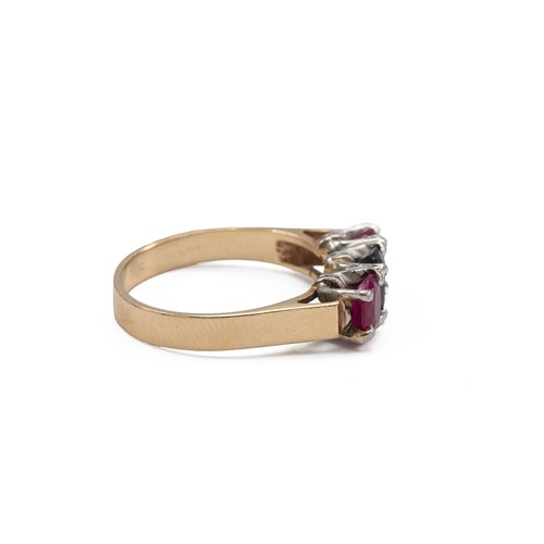 45 - Yellow metal, sapphire and ruby three stone ring in a claw setting with three mixed cut stones, fing... 