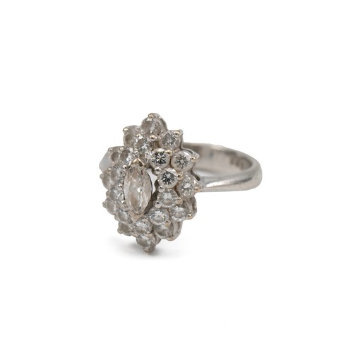 46 - White metal and diamond cluster ring, the central marquise stone measuring approximately 0.20 carats... 