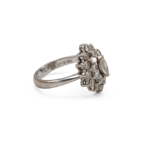 46 - White metal and diamond cluster ring, the central marquise stone measuring approximately 0.20 carats... 