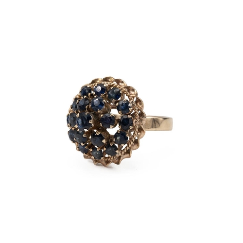 59 - Yellow metal and sapphire cocktail ring, with three separate layers, with two rope twist sections to... 