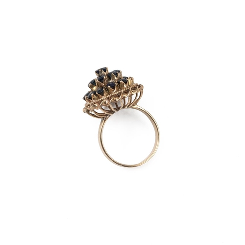 59 - Yellow metal and sapphire cocktail ring, with three separate layers, with two rope twist sections to... 