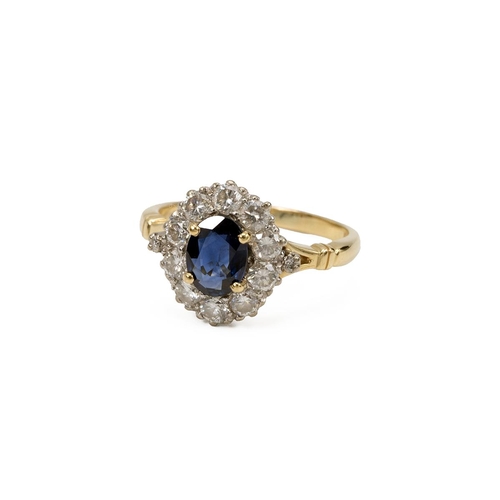 61 - 18ct gold and sapphire ring, the oval mixed cut sapphire in a four-claw setting, surrounded by ten b... 