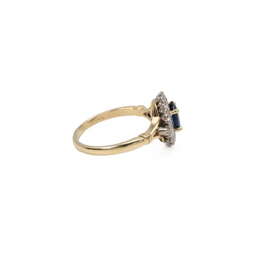 61 - 18ct gold and sapphire ring, the oval mixed cut sapphire in a four-claw setting, surrounded by ten b... 