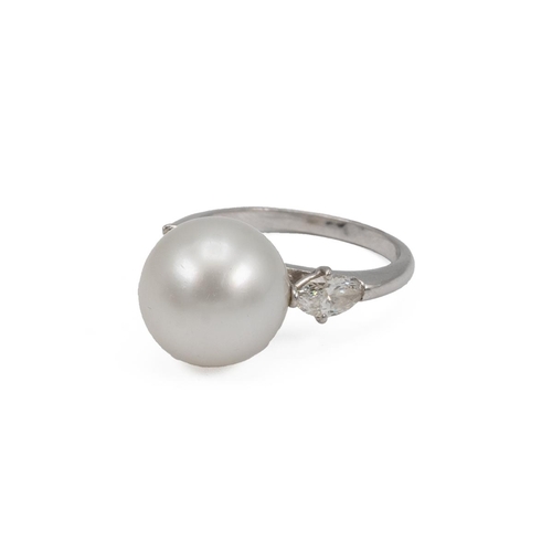 77 - Cultured pearl and diamond ring, centring on a large cultured pearl measuring 13mm, between shoulder... 