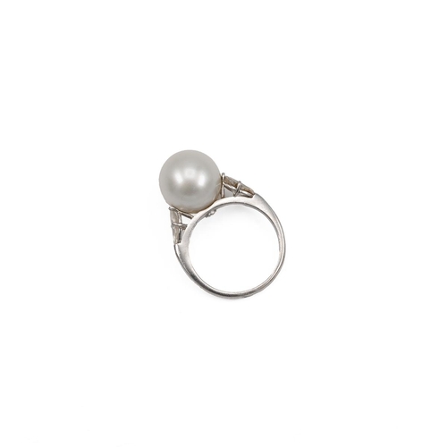 77 - Cultured pearl and diamond ring, centring on a large cultured pearl measuring 13mm, between shoulder... 