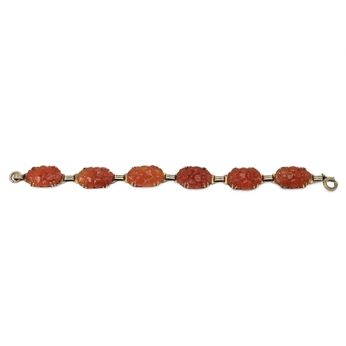 133 - Carnelian bracelet, in unmarked yellow metal, the six oval stones carved with foliage, 19cm long. Te... 