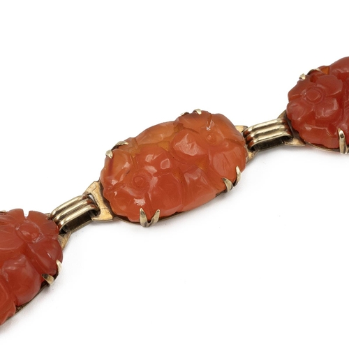 133 - Carnelian bracelet, in unmarked yellow metal, the six oval stones carved with foliage, 19cm long. Te... 