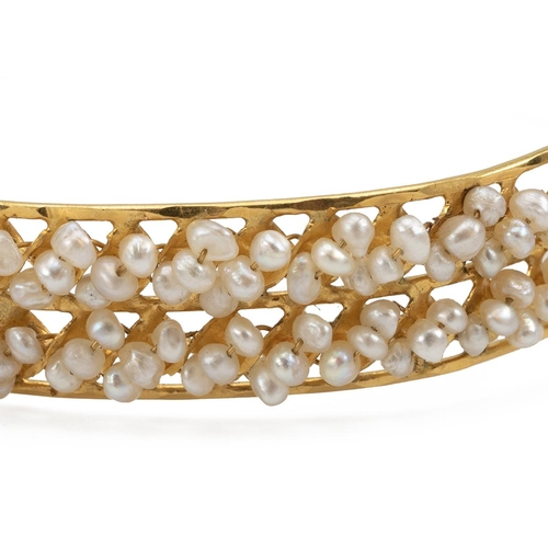 149 - Bahrain yellow metal 22ct tested seed pearl bangle, decorated with two bands of triple pearls with p... 