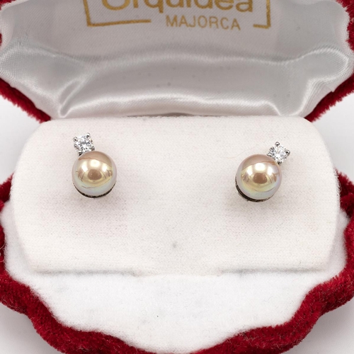 174 - Pair of white metal and cultured pearl earrings, along with another similar pair, both cased.