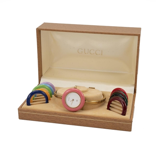 249 - Ladies Gucci 11/12 gold tone bangle watch with colour change bezels. White dial with 11 coloured int... 