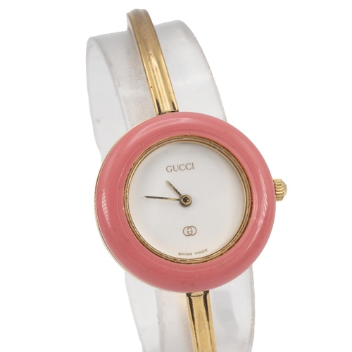 249 - Ladies Gucci 11/12 gold tone bangle watch with colour change bezels. White dial with 11 coloured int... 