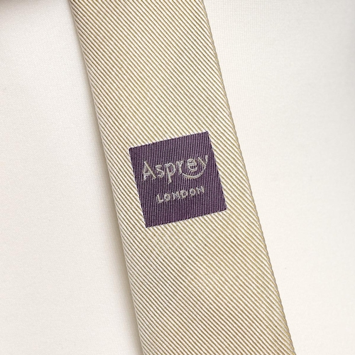 337 - Asprey of London: new old stock, a yellow monochrome woven silk tie in a branded cardboard box.