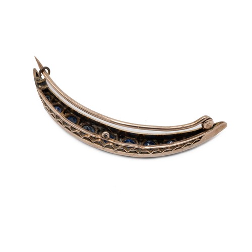 186 - Diamond and sapphire crescent shaped brooch, with 9 near matched graduating sapphires each stone fla... 