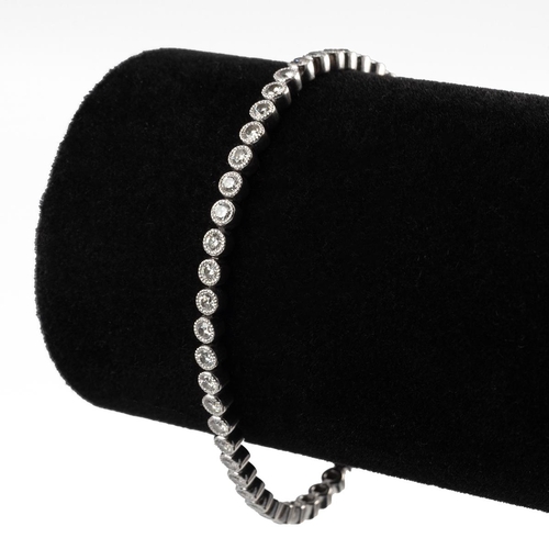 10 - A diamond tennis bracelet, set with 50 brilliant cut diamonds, totalling approximately 3.5 carats,  ... 