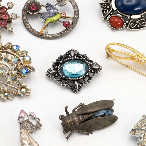 12 - Collection of vintage costume jewellery brooches, including some silver examples.