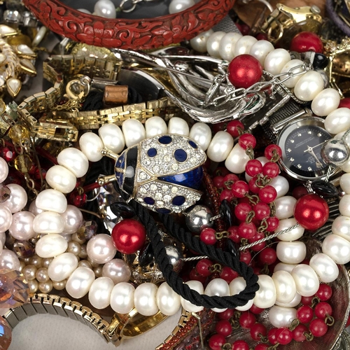 28 - A collection of costume jewellery including necklaces, bangles, watches, earrings, Cinnabar bangle e... 