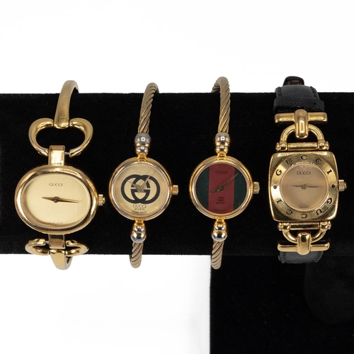 36 - Collection of four lady's Gucci watches, two on wire twist straps.