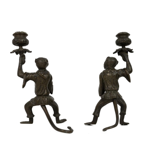 66 - Pair of novelty candlesticks in the form of monkeys in costumes, of bronzed metal. H 22cm.