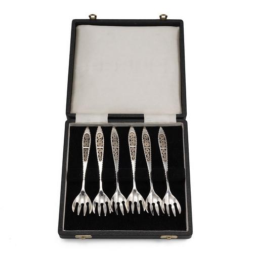 76 - Set of six white metal dessert forks, each with a pierced handle, stamped 