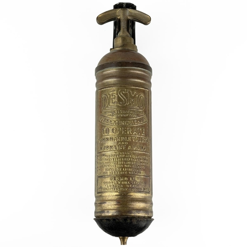 126 - Vintage brass Desmo fire extinguisher, mounted on black metal stand.